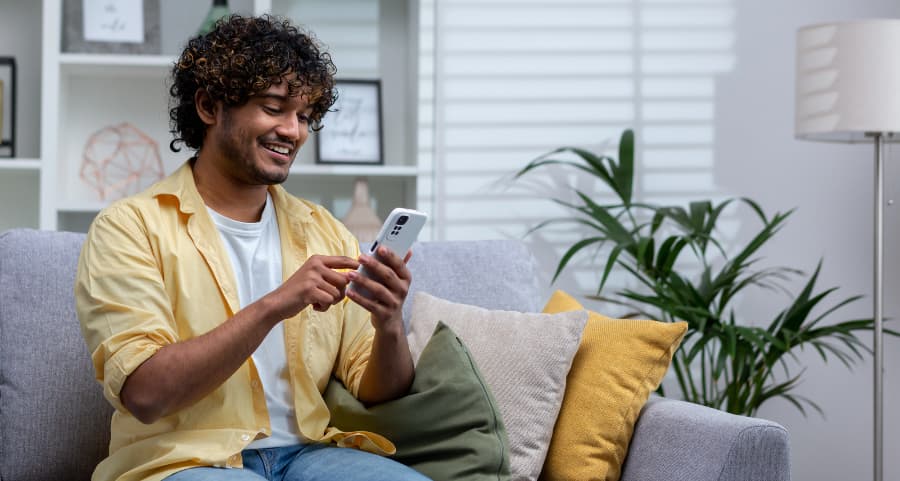 Man navigating a home security app on his cell phone